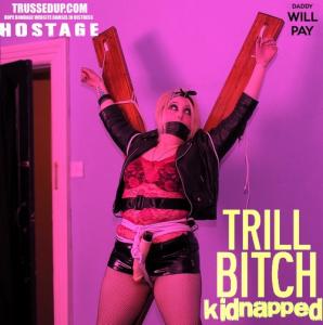 trussedup.com - trashy goth girl  PVC mini hostage tied up gagged st Andrews cross bondage thumbnail